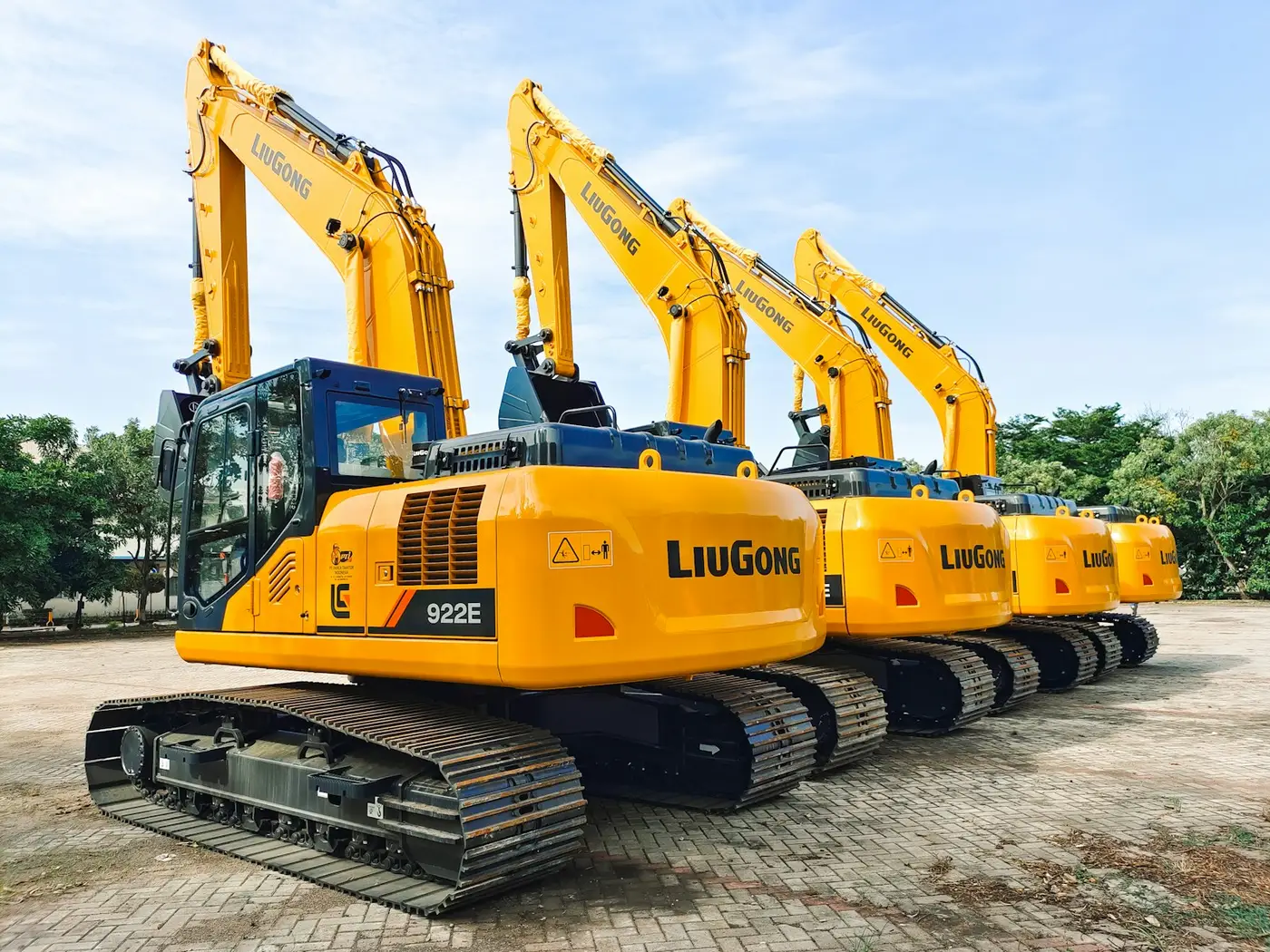 Four new LiuGong excavators lined up on a dealer lot